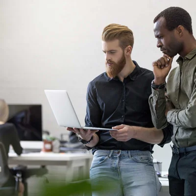 Two Worried Young Business Men Looking at Laptop Two Worried Young Business Men Looking at Laptop