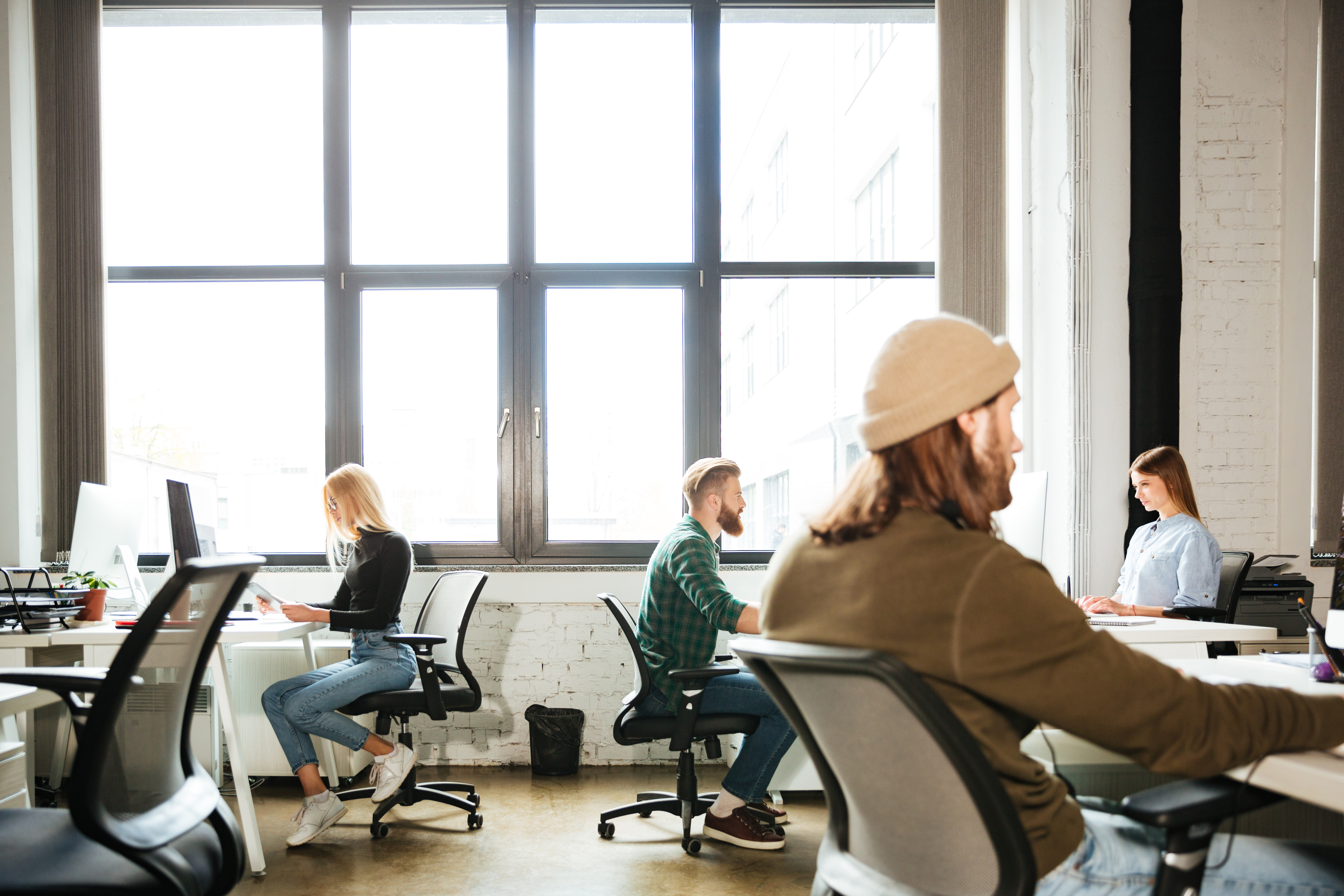 Colleagues in a work office using computers