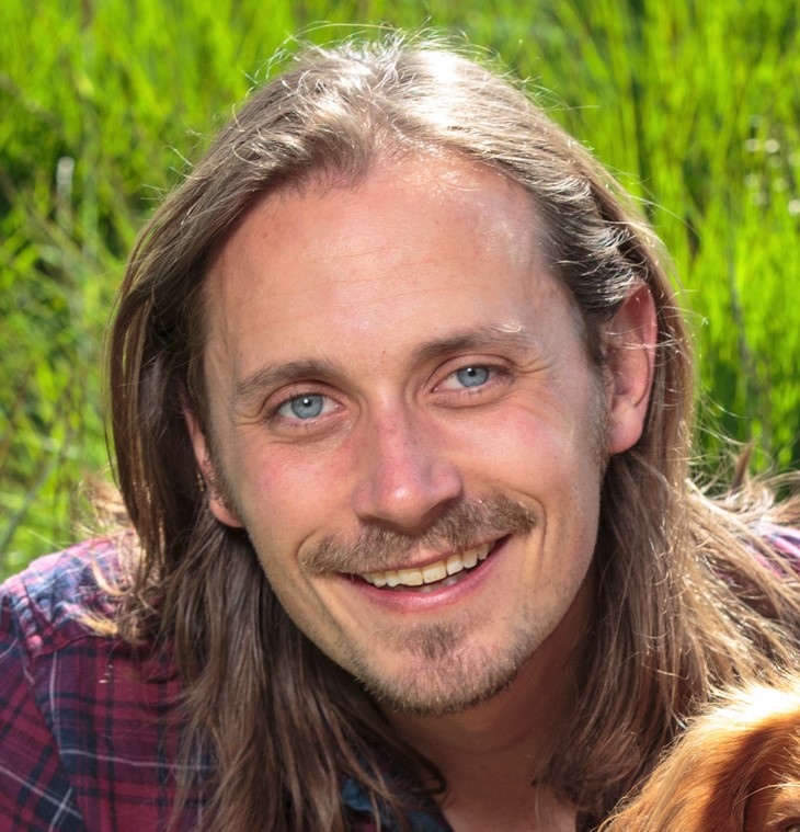 Photo of CWT trainer smiling with grassy background