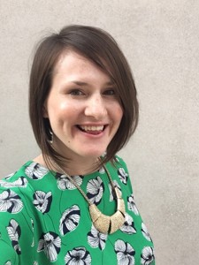 Angela, a woman with short brown hair smiling at the camera.