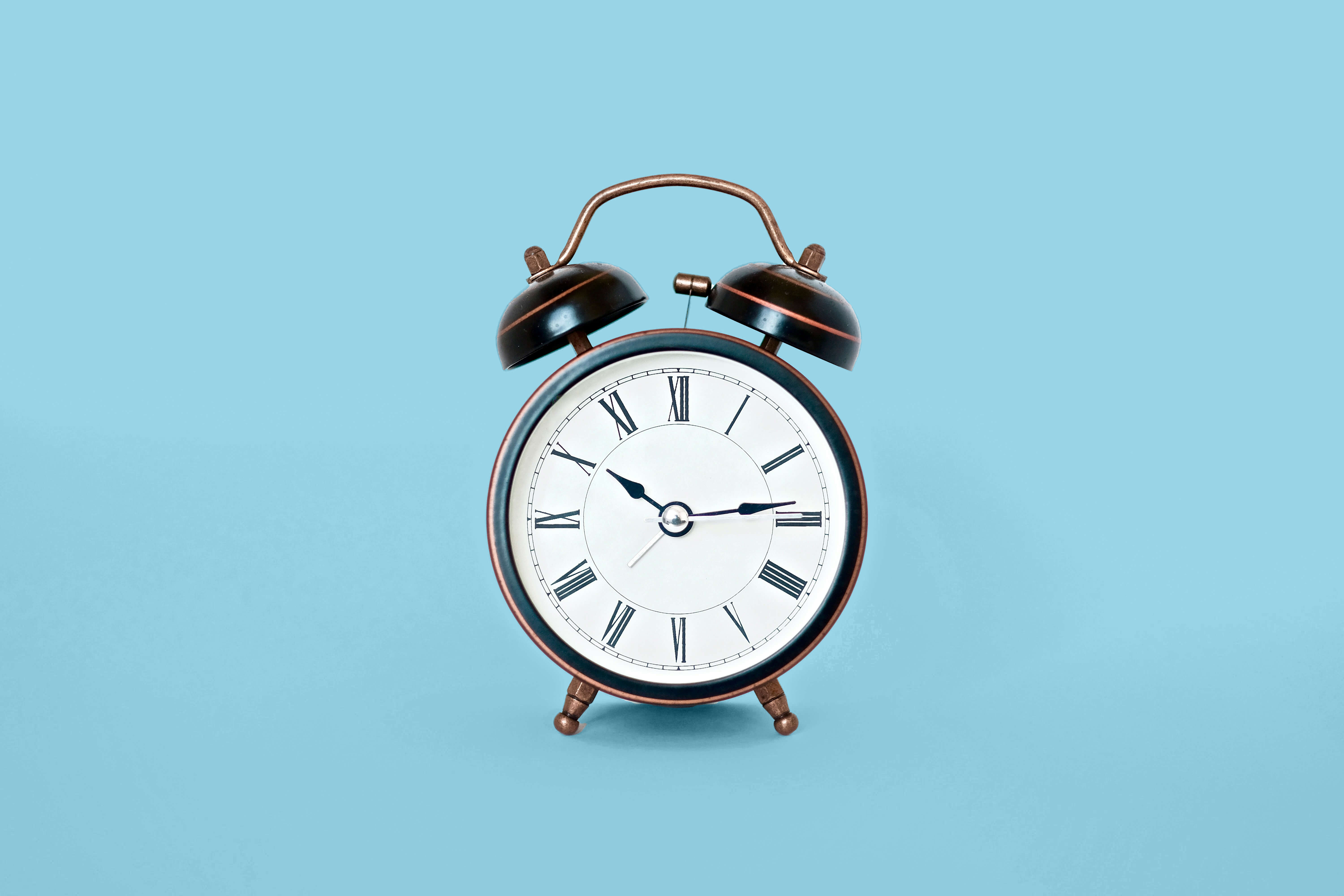 Alarm clock on blue background