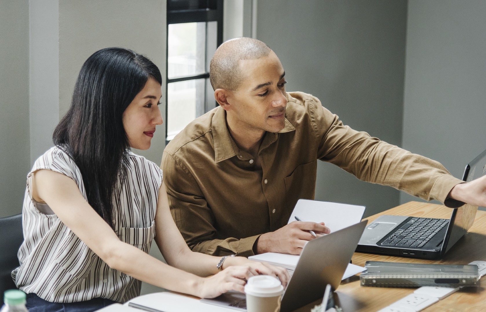 Two people looking at computer screens